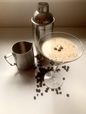 Espresso Martini tools: cocktail shaker, espresso maker and chilled martini glass.